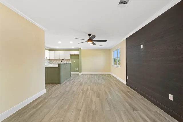 a view of a kitchen with wooden floor and a sink