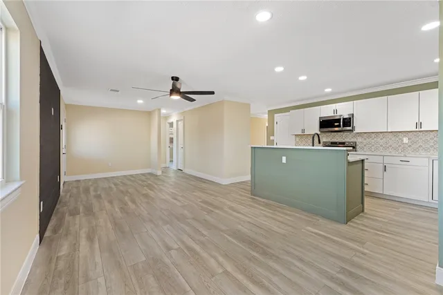 a view of kitchen with wooden floor and electronic appliances