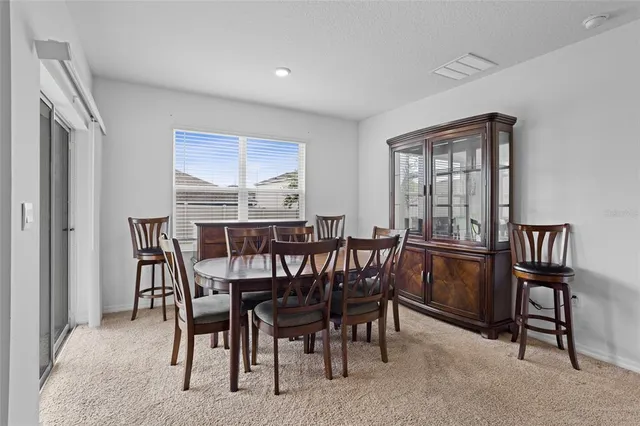 a view of a dining room with furniture and a window