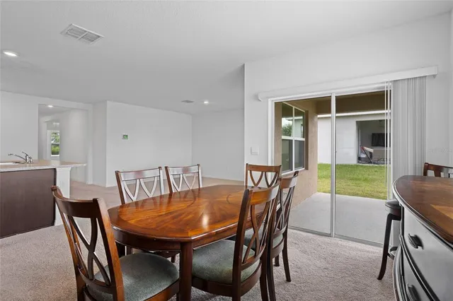 a view of a dining room with furniture and a window
