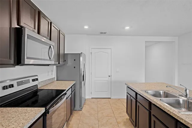 a kitchen with a sink stove and refrigerator