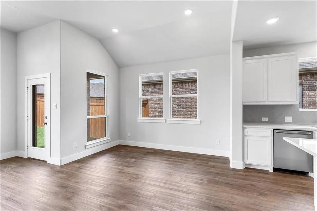 6246 Shasta Creek Road Celina, TX 75009 - Photo 7 of 24 an empty room with wooden floor and windows