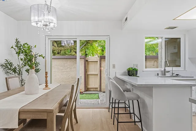 a dining room with furniture a potted plant and a chandelier