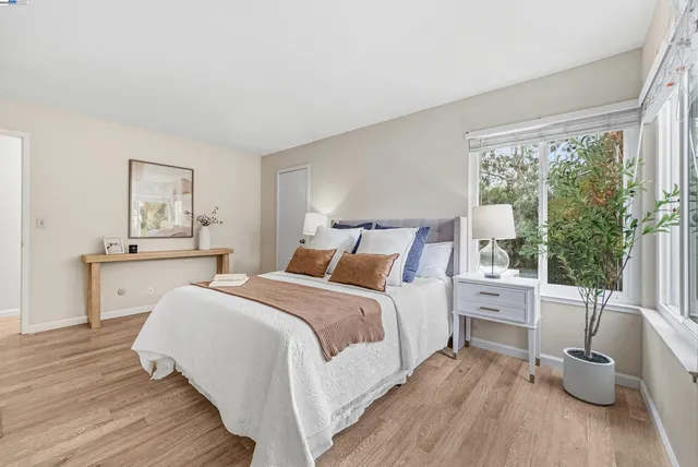 a bed room with a bed and a large window