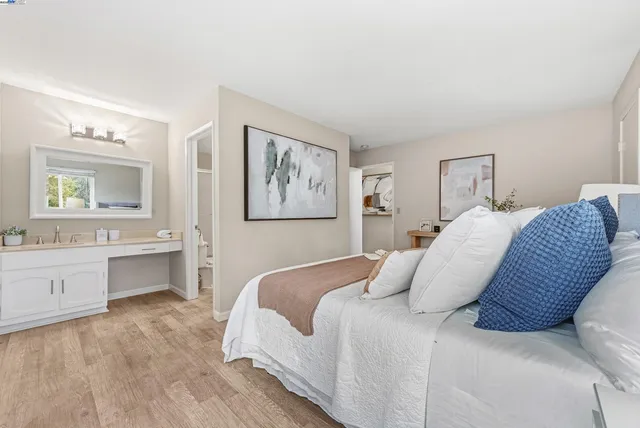 a bedroom with a large bed and a chandelier