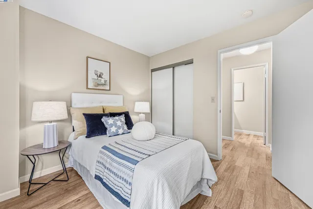 a bedroom with a bed and a painting on the wall