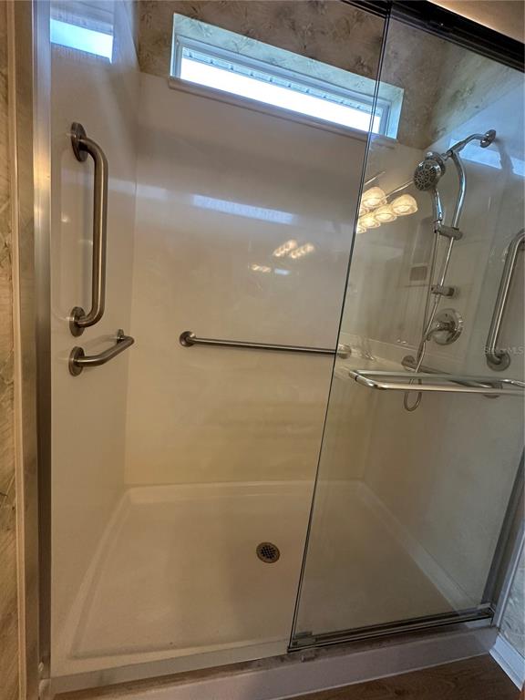 12900 Southeast 97th Terrace Road Summerfield, FL 34491 - Photo 21 of 28 a bathroom with a glass door shower
