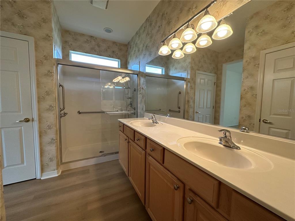 12900 Southeast 97th Terrace Road Summerfield, FL 34491 - Photo 22 of 28 a bathroom with a sink vanity granite and a mirror