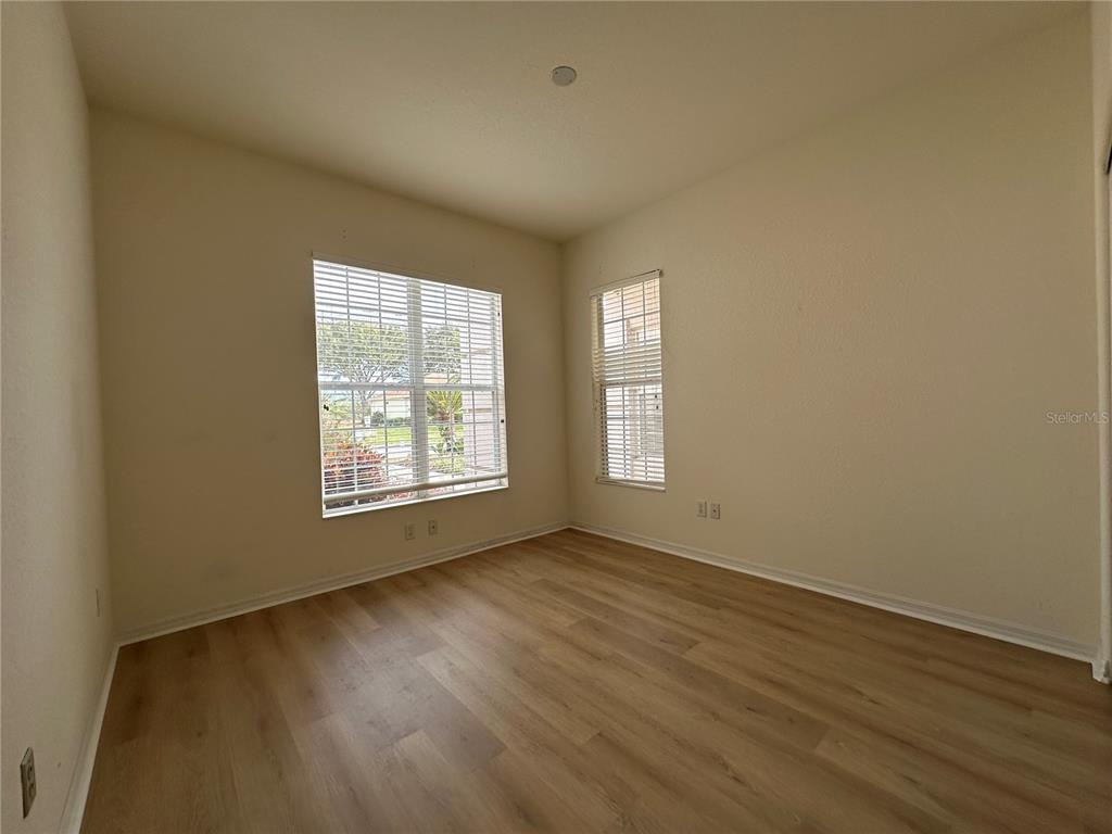 12900 Southeast 97th Terrace Road Summerfield, FL 34491 - Photo 25 of 28 a view of an empty room with wooden floor and a window