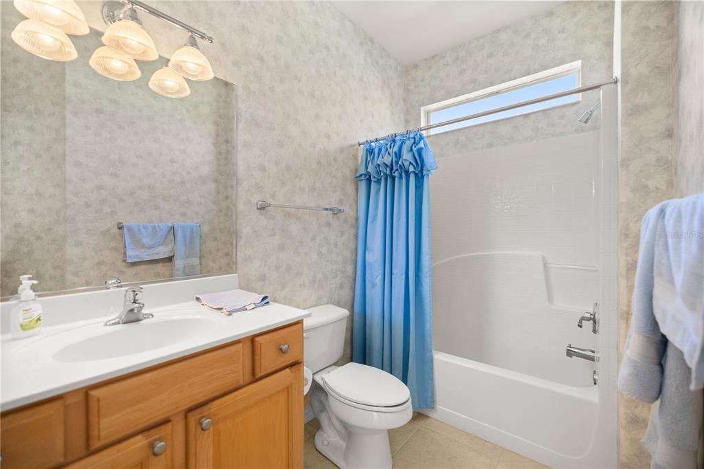 12900 Southeast 97th Terrace Road Summerfield, FL 34491 - Photo 26 of 28 a bathroom with a sink toilet and shower