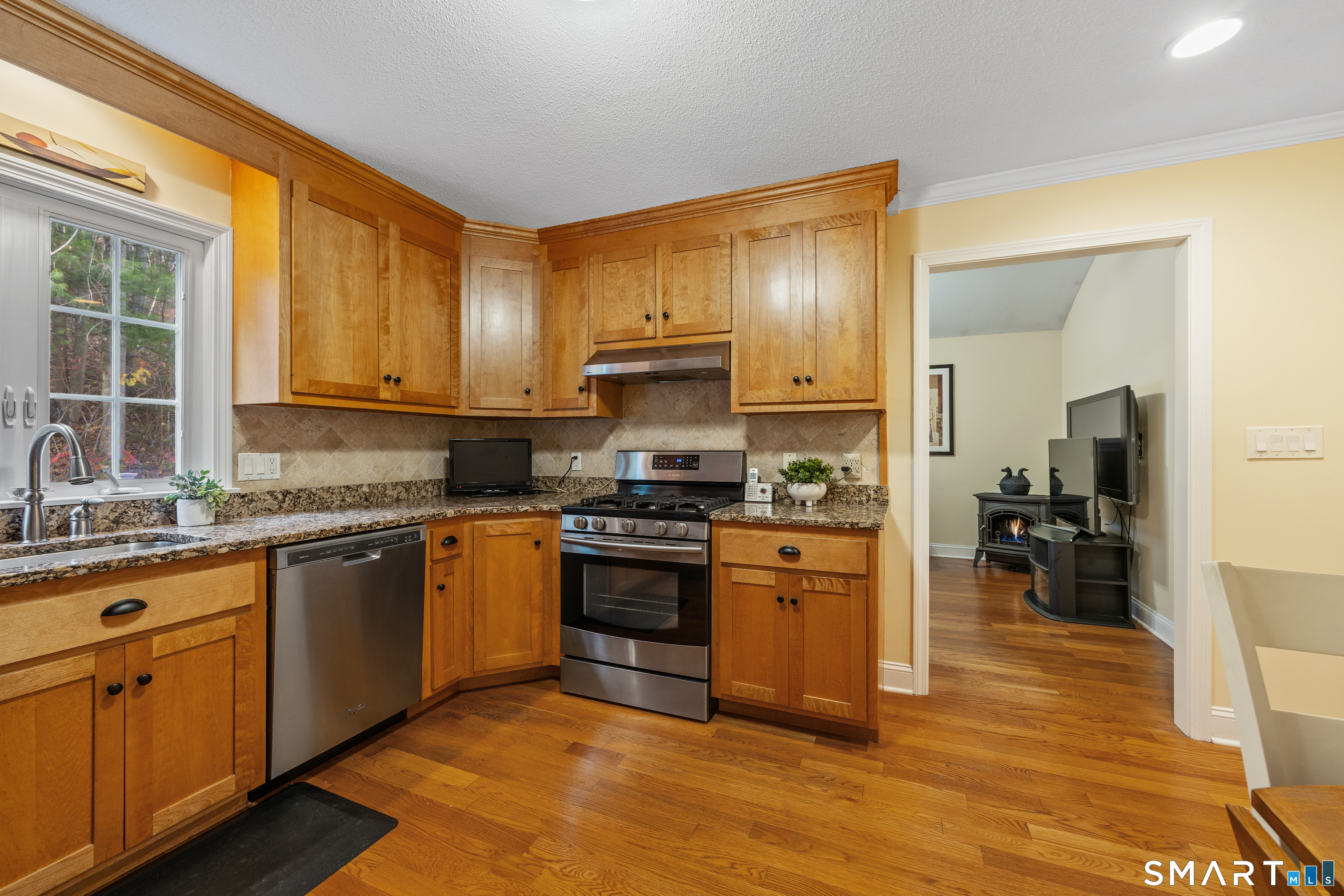 49 Quarry Village Road, Unit 49 Cheshire, CT 06410 - Photo 11 of 37 a kitchen with granite countertop wooden floors and stainless steel appliances