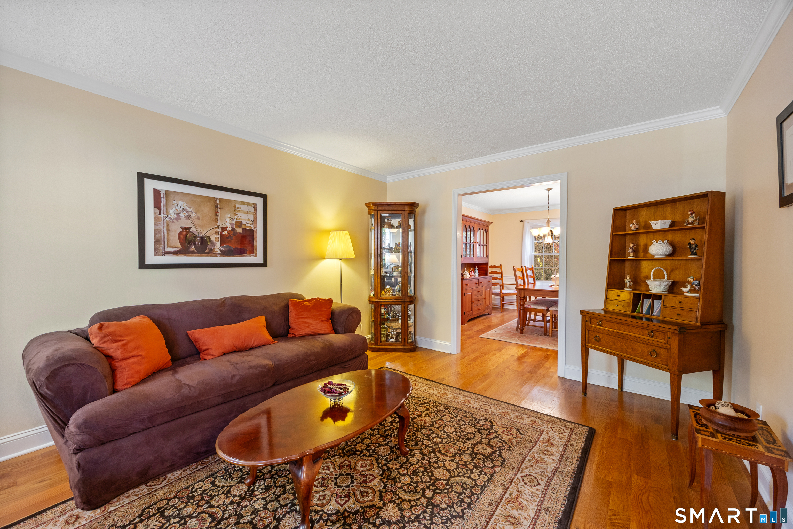 49 Quarry Village Road, Unit 49 Cheshire, CT 06410 - Photo 19 of 37 a living room with furniture wooden floor and a table