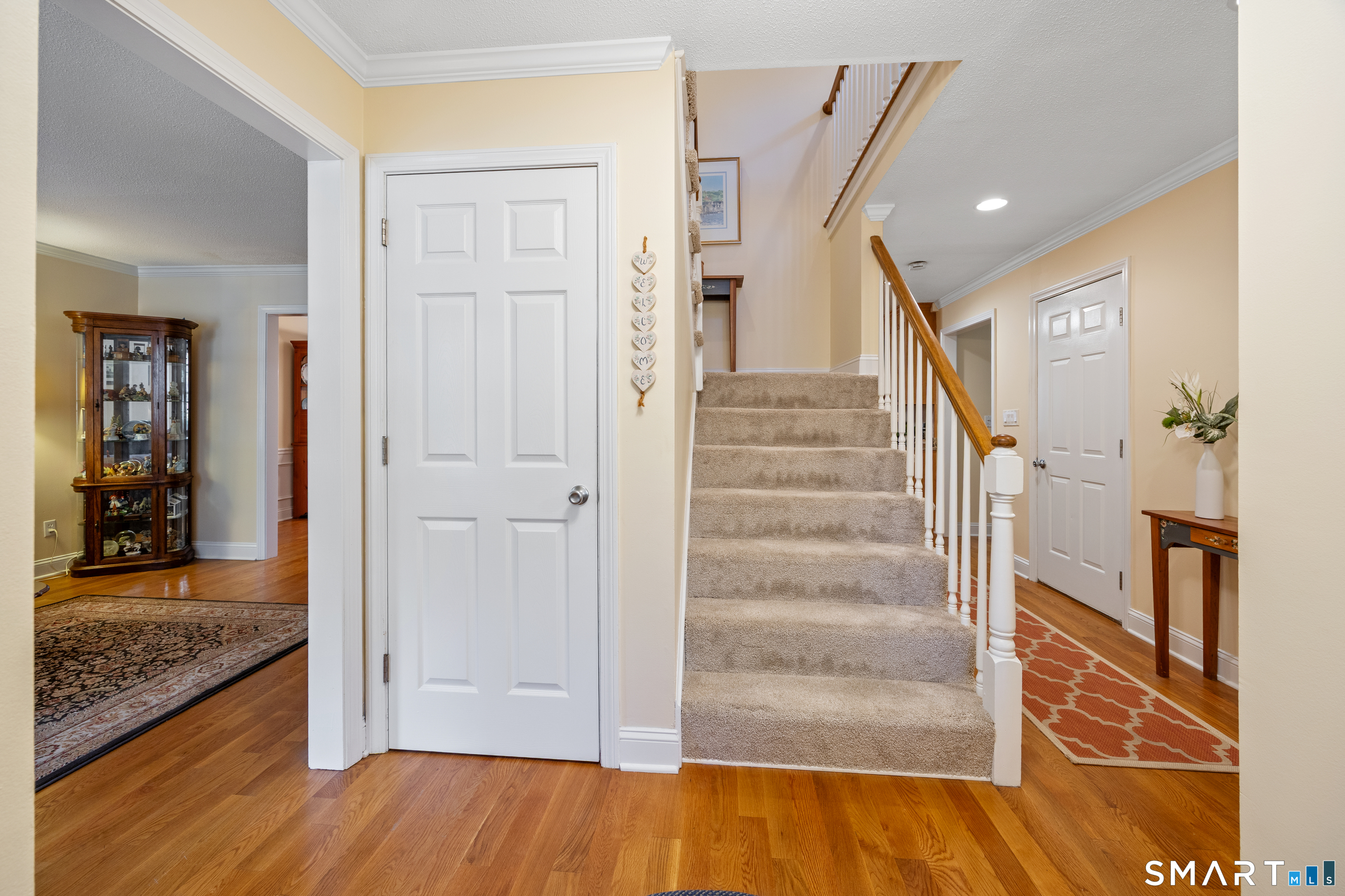 49 Quarry Village Road, Unit 49 Cheshire, CT 06410 - Photo 21 of 37 a view of a hallway with wooden floor and staircase