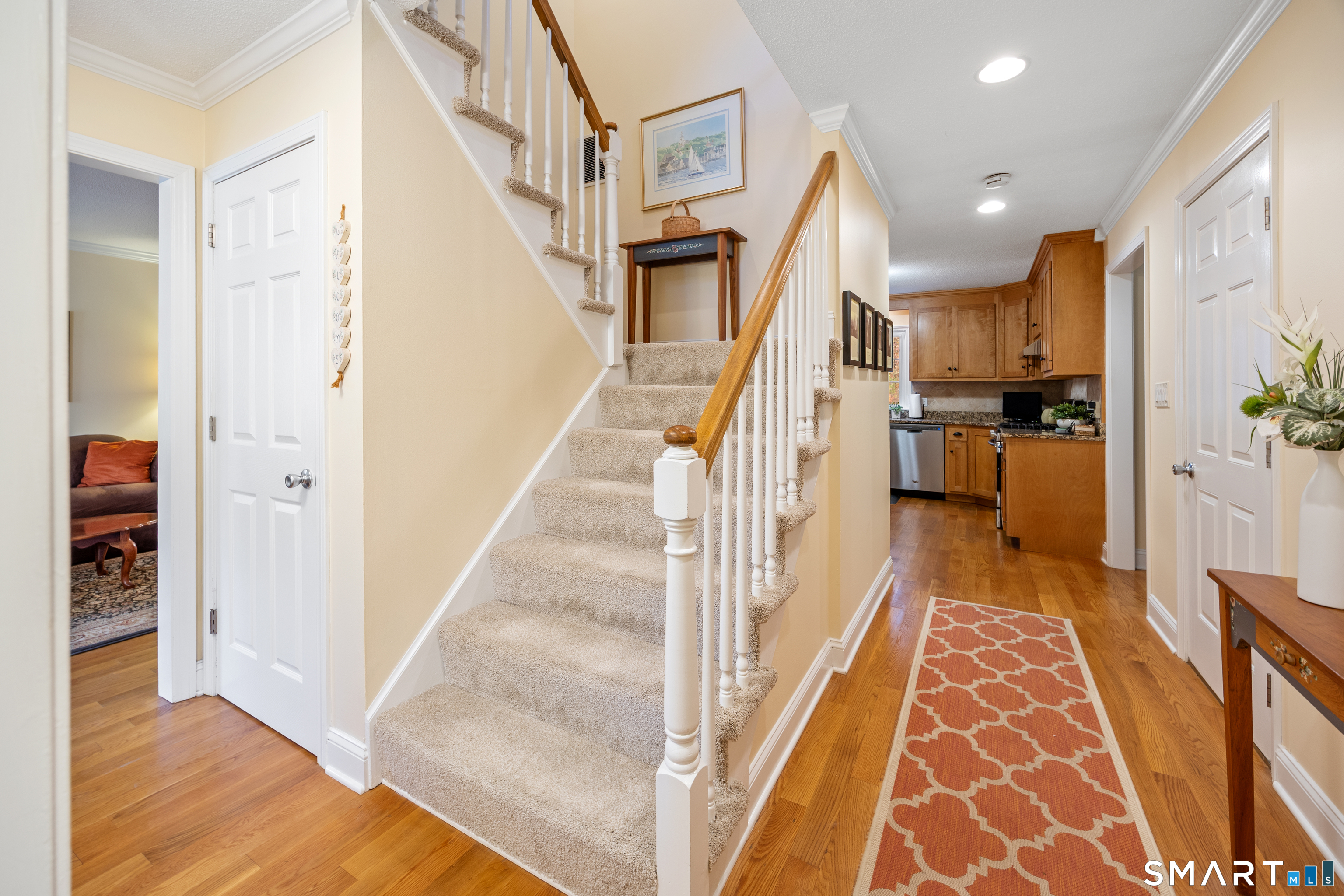 49 Quarry Village Road, Unit 49 Cheshire, CT 06410 - Photo 23 of 37 a view of a hallway with wooden floor and staircase