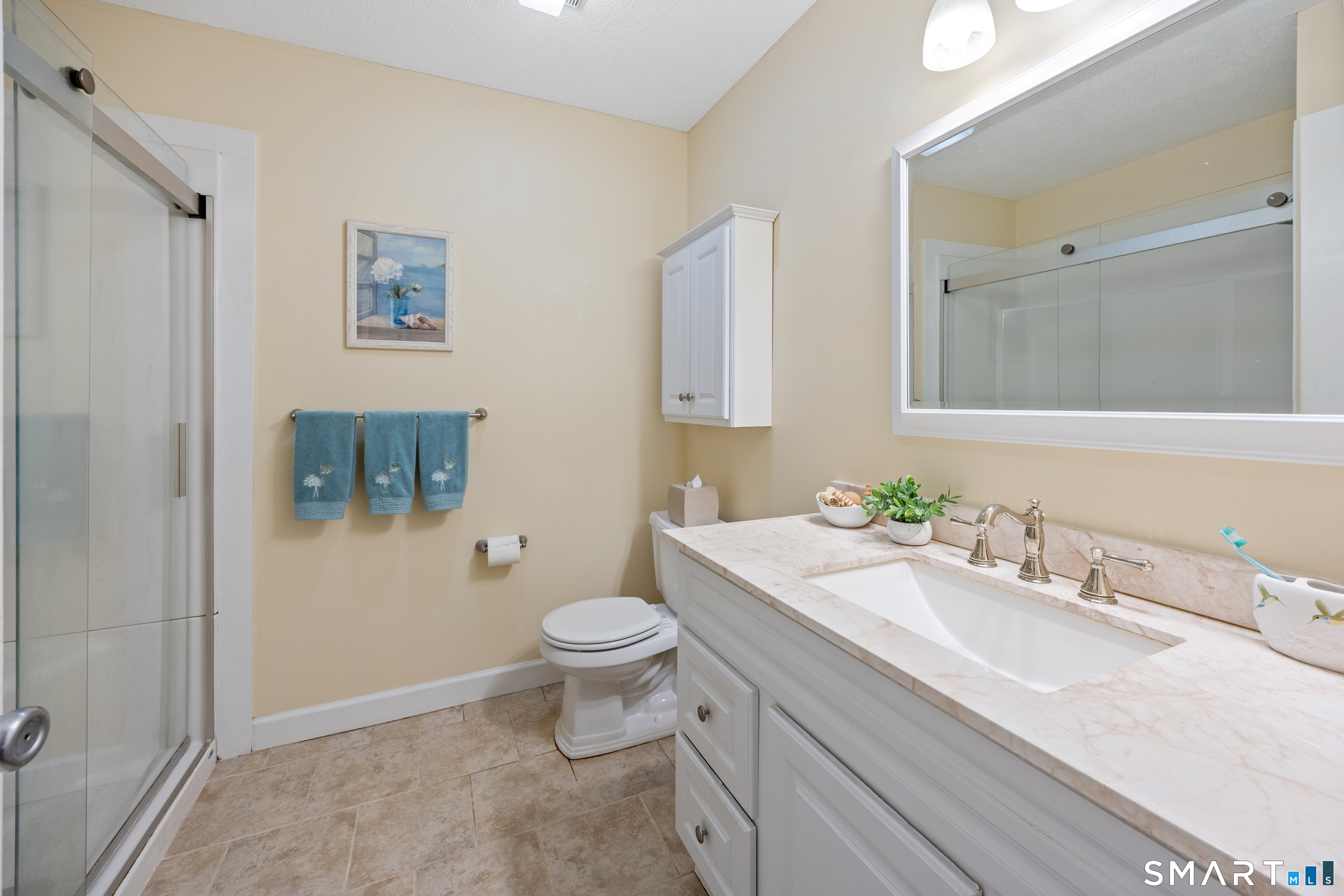 49 Quarry Village Road, Unit 49 Cheshire, CT 06410 - Photo 31 of 37 a bathroom with a sink toilet and mirror