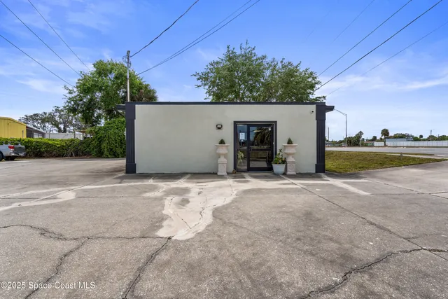a view of a house with a yard and lake view