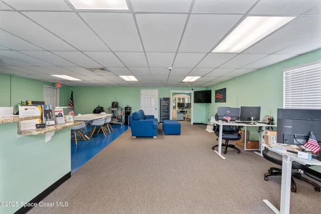 a living room with lots of furniture and a large window