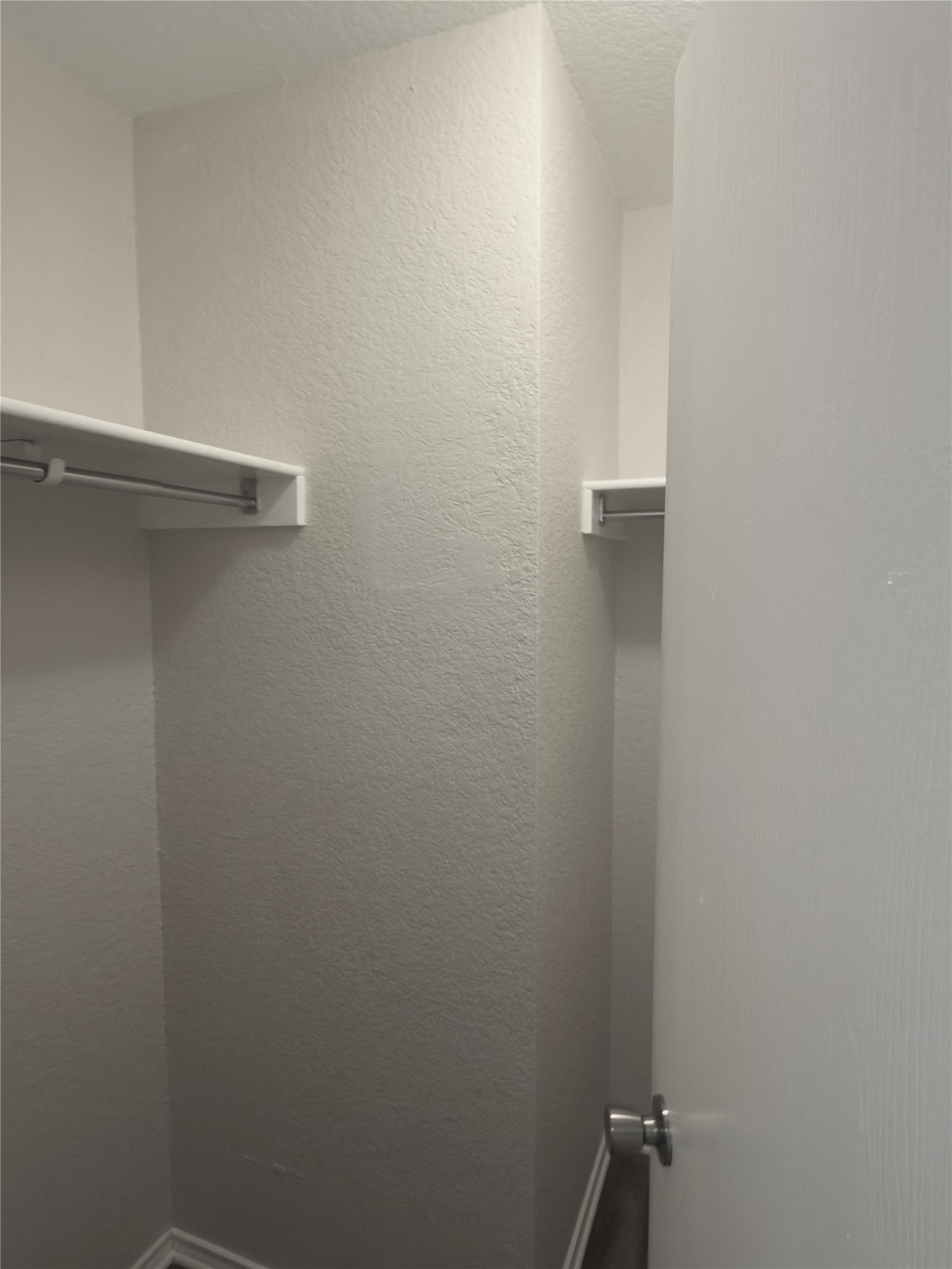 255 Myrtle Street Kyle, TX 78640 - Photo 25 of 31 Walk-in closet featuring white painted walls and integrated shelving with metal hanging rods