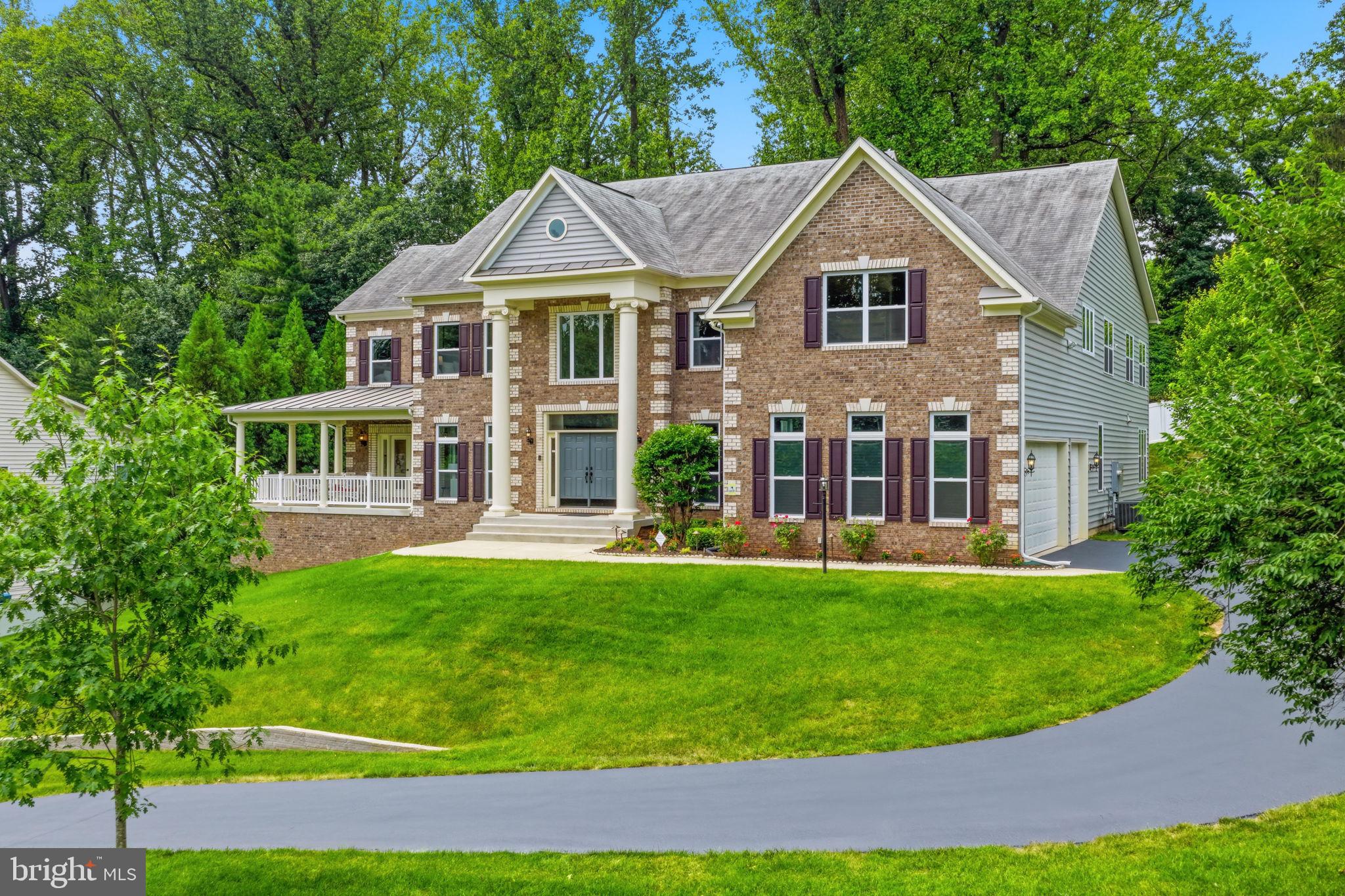 7821 Old Falls Road McLean, VA 22102 - Photo 48 of 62 a front view of a house with a garden and porch