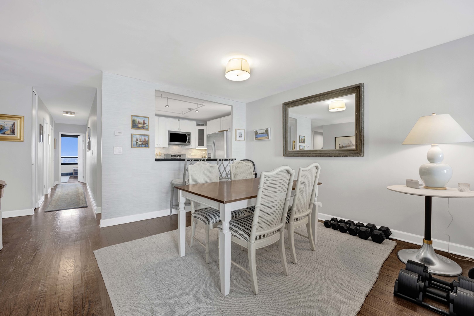 3150 North Sheridan Road, Unit 14A Chicago, IL 60657 - Photo 11 of 31 a view of a dining room with furniture and wooden floor