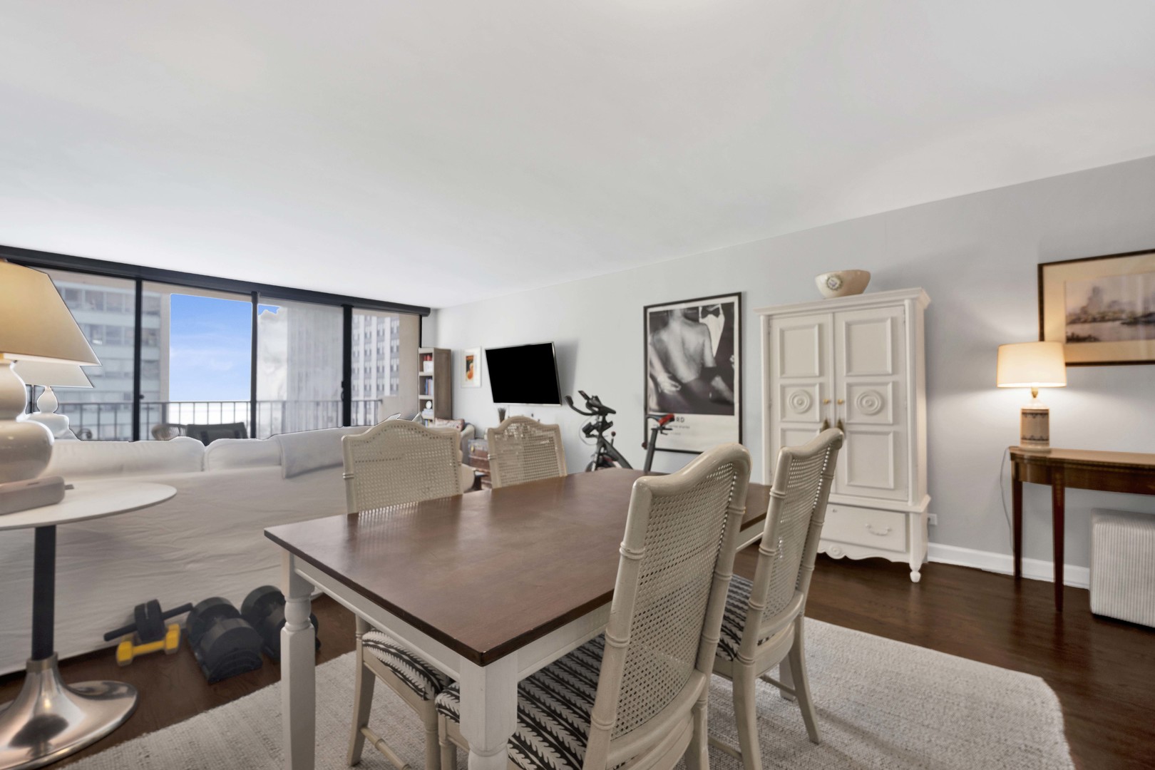 3150 North Sheridan Road, Unit 14A Chicago, IL 60657 - Photo 13 of 31 a view of a dining room with furniture and wooden floor