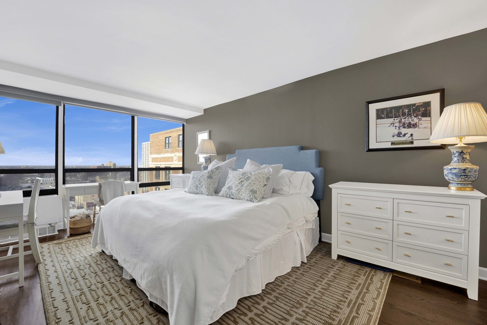 3150 North Sheridan Road, Unit 14A Chicago, IL 60657 - Photo 15 of 31 a bedroom with a bed a lamp and large window