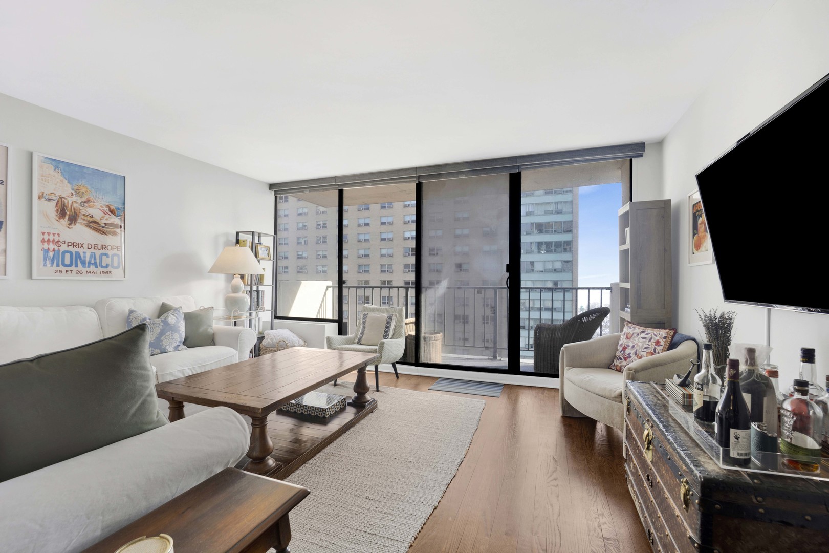 3150 North Sheridan Road, Unit 14A Chicago, IL 60657 - Photo 7 of 31 a living room with furniture floor to ceiling window and a flat screen tv