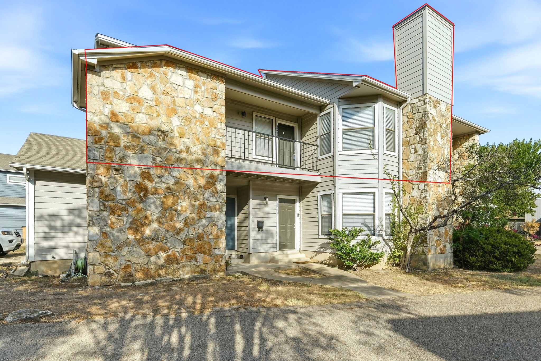 8804 Schick Road, Unit C Austin, TX 78729 - Photo 2 of 17 Natural stone accents and dual bay windows define this multi-level exterior architecture.