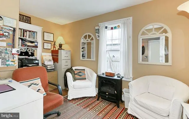 a living room with furniture fireplace and a flat screen tv
