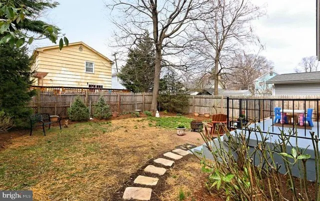 a view of a house with backyard and sitting area