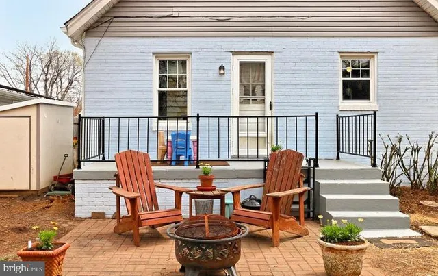 a view of a patio with chair and tables