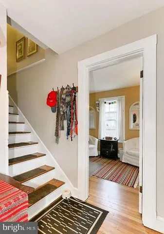 a view of a hallway and a livingroom with wooden floor