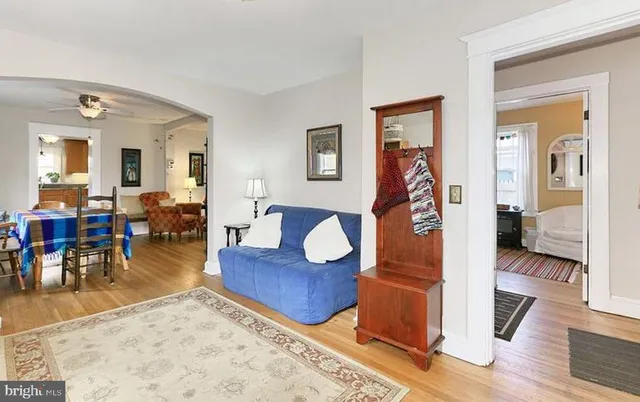 a living room with furniture and wooden floor