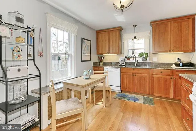 a kitchen with a sink appliances and cabinets