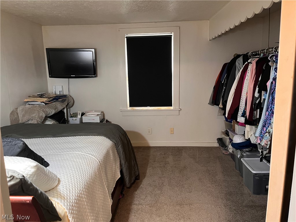 175 Wayne Street Rittman, OH 44270 - Photo 34 of 35 Carpeted room with a single window featuring a dark roller shade