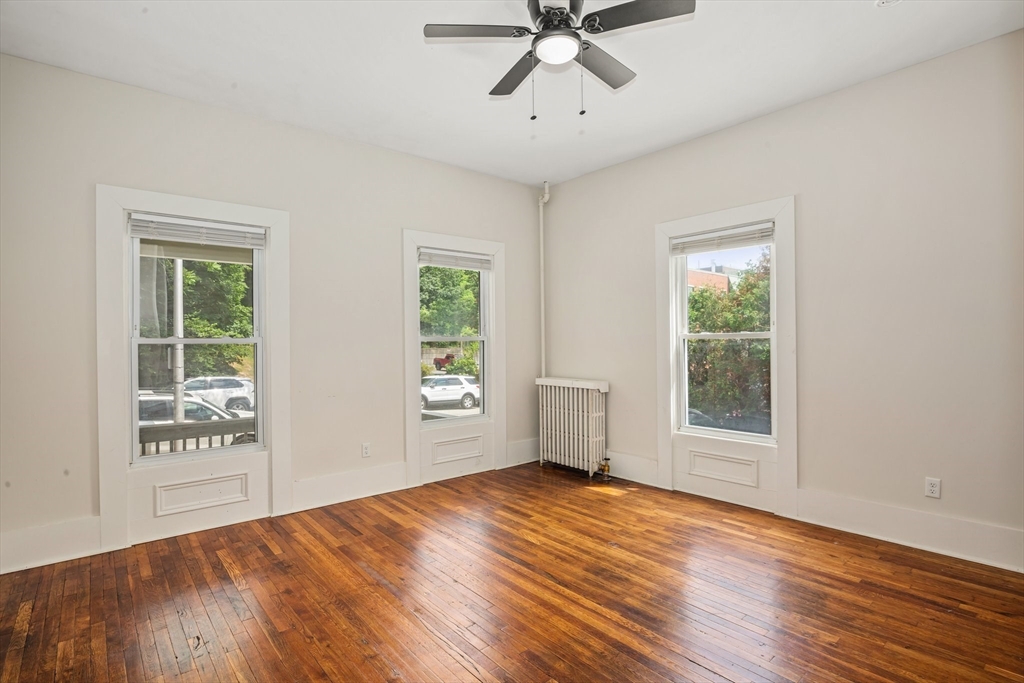 35 Oak Avenue Worcester, MA 01605 - Photo 4 of 34 a view of empty room with wooden floor and fan