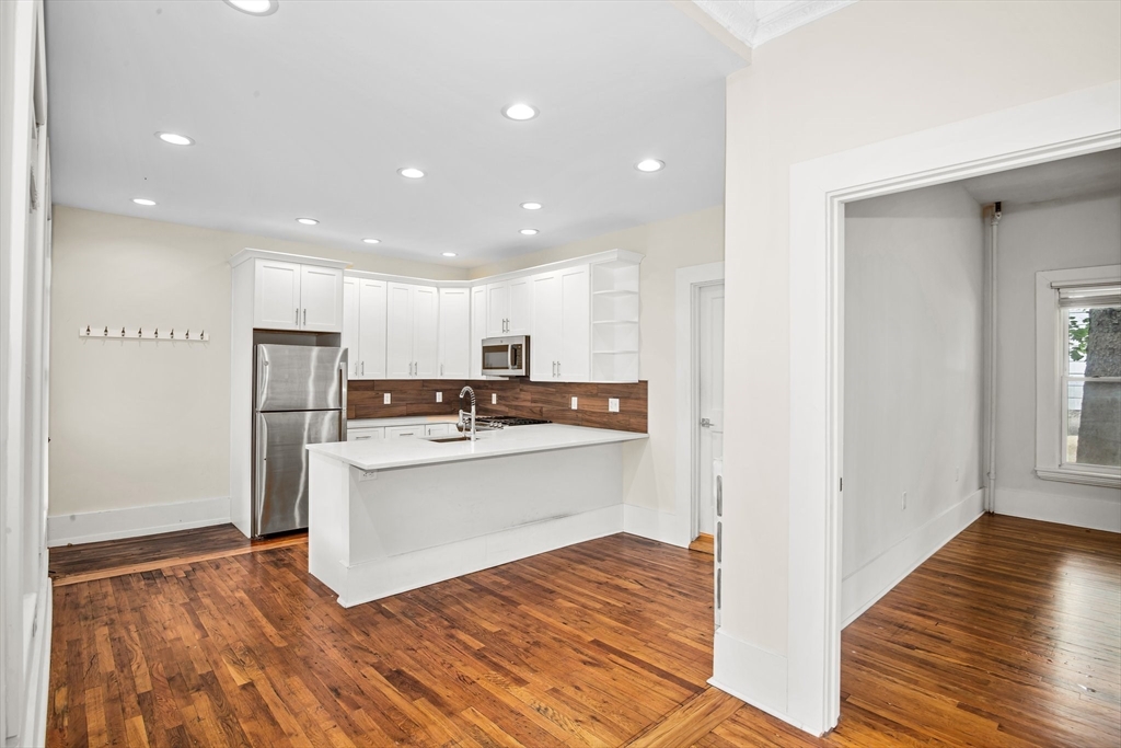 35 Oak Avenue Worcester, MA 01605 - Photo 7 of 34 a kitchen with stainless steel appliances granite countertop a refrigerator and a stove top oven