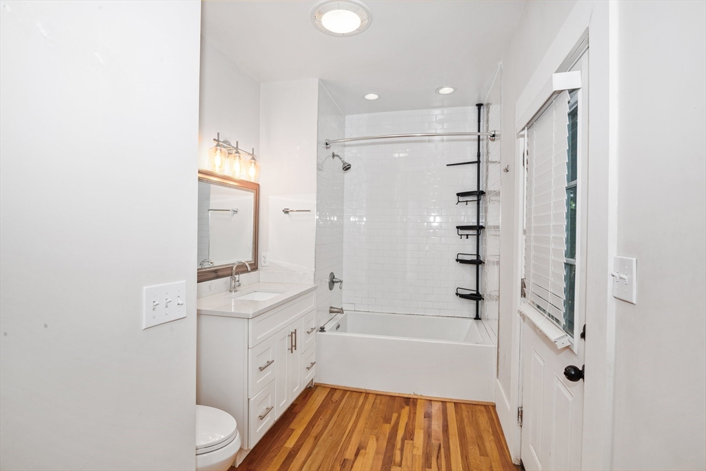 35 Oak Avenue Worcester, MA 01605 - Photo 10 of 34 a bathroom with a bathtub shower sink vanity and toilet