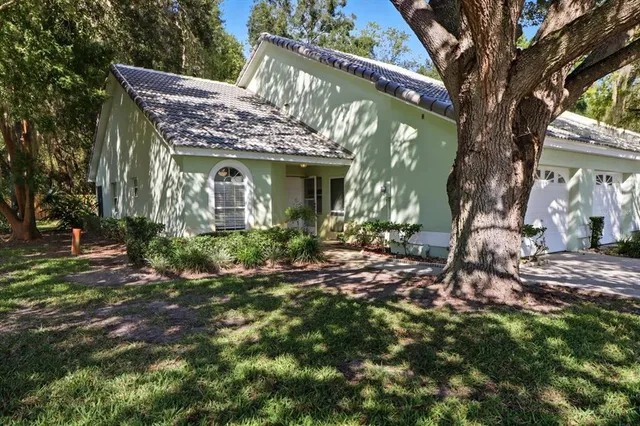 a view of a house with a tree in the yard