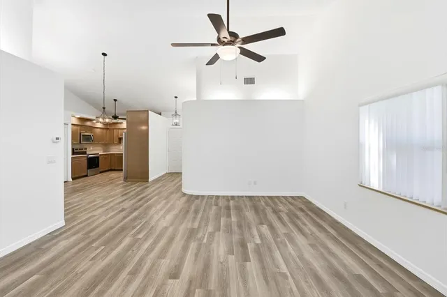 a view of a kitchen with a sink cabinets and wooden floor