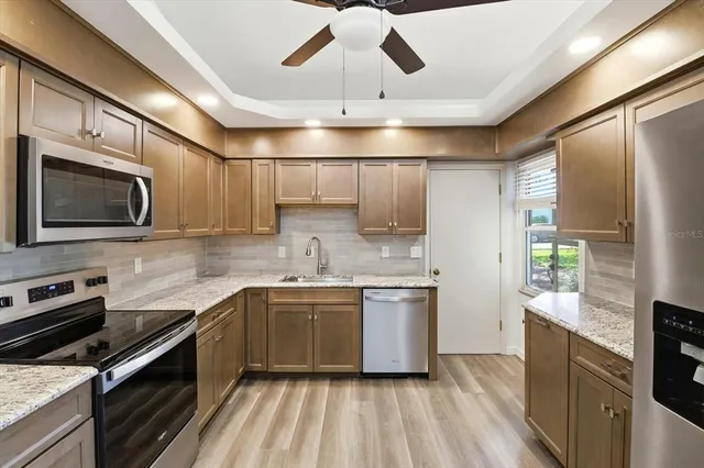 a kitchen with stainless steel appliances a sink stove and refrigerator