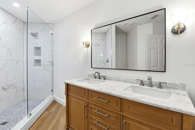a bathroom with a granite countertop sink mirror and double