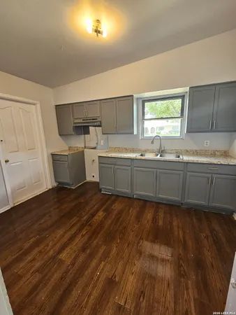 a large kitchen with a sink and window