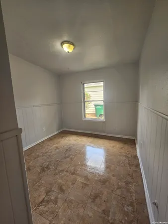 an empty room with a empty space and windows