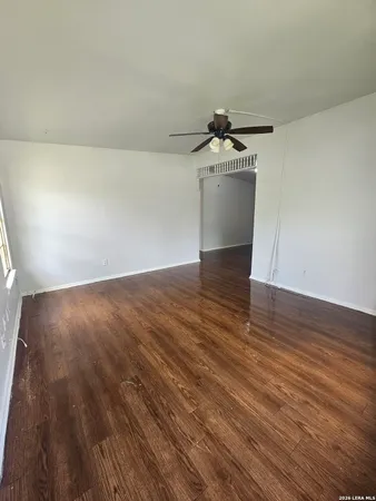 a view of a room with wooden floor and sink