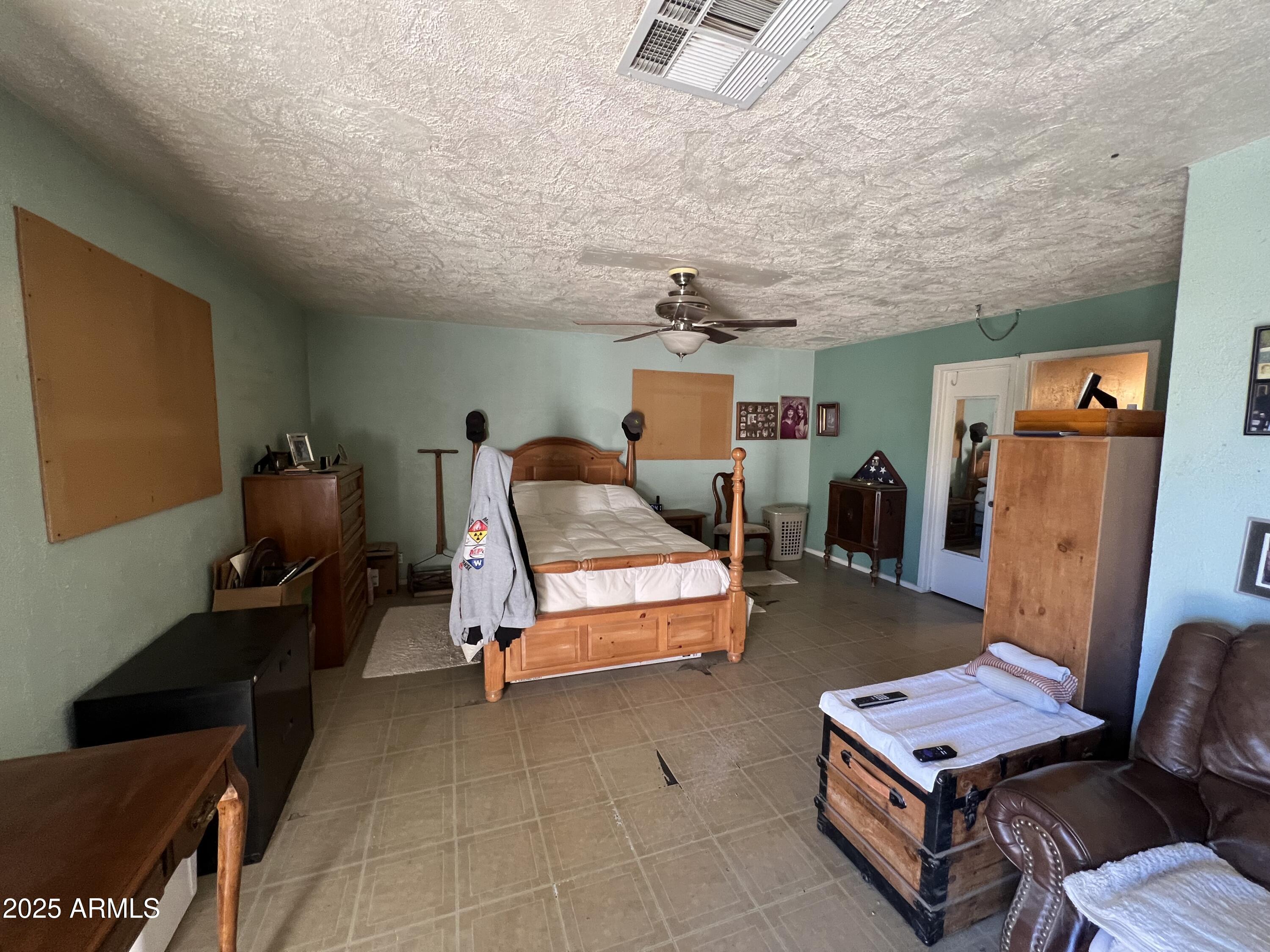 7431 North Alsup Road Litchfield Park, AZ 85340 - Photo 11 of 31 a bedroom with furniture and a chair