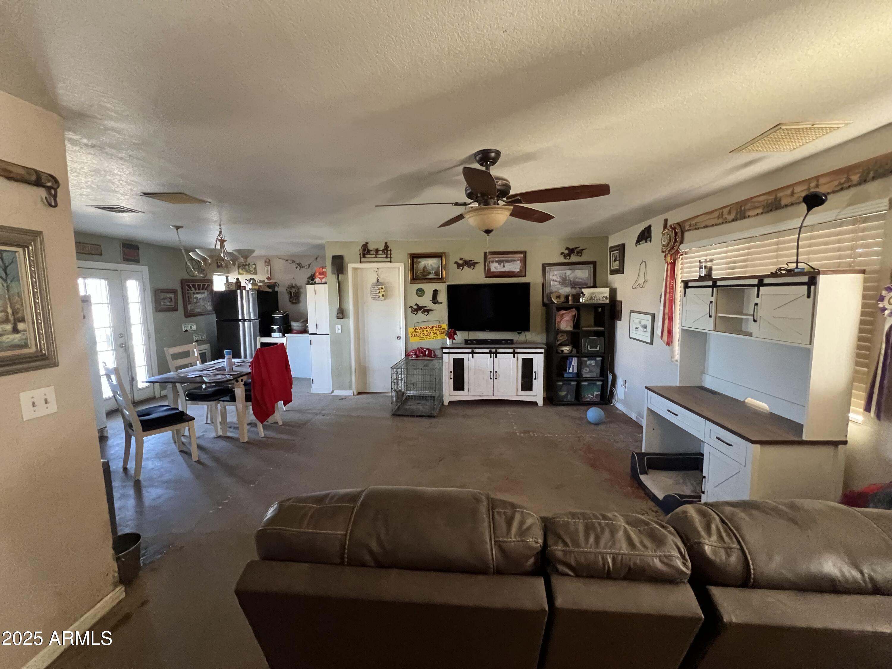 7431 North Alsup Road Litchfield Park, AZ 85340 - Photo 6 of 31 a living room with furniture and a flat screen tv