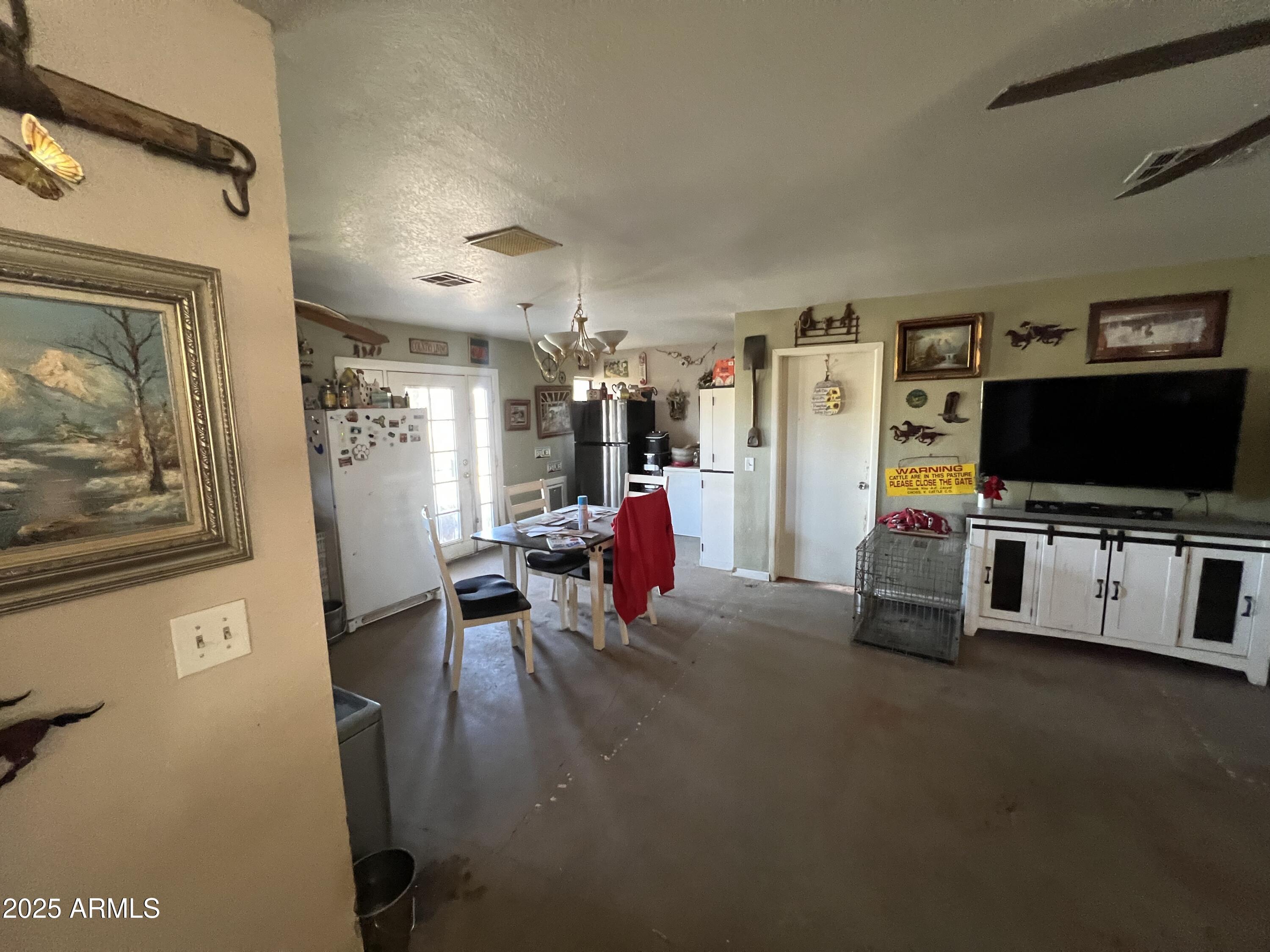 7431 North Alsup Road Litchfield Park, AZ 85340 - Photo 8 of 31 a living room with furniture and a flat screen tv