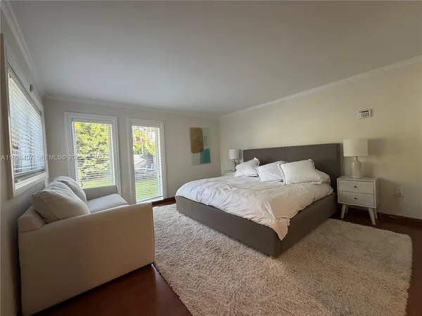 a spacious bedroom with a bed and glass couch