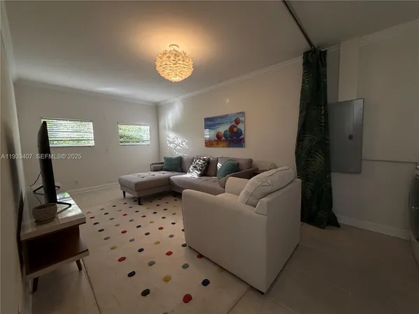 a living room with furniture and a mirror